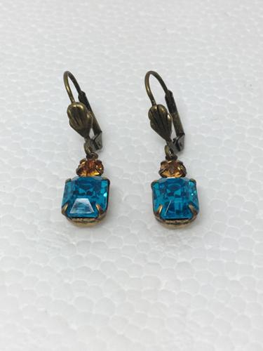 18mm Vintage Glass Octagon Aquamarine Stone, Swarovski Topaz Crystal Earrings on Antique Brass shell lever-back wires. 

Stones made in Austria and Germany. Settings made in USA. 